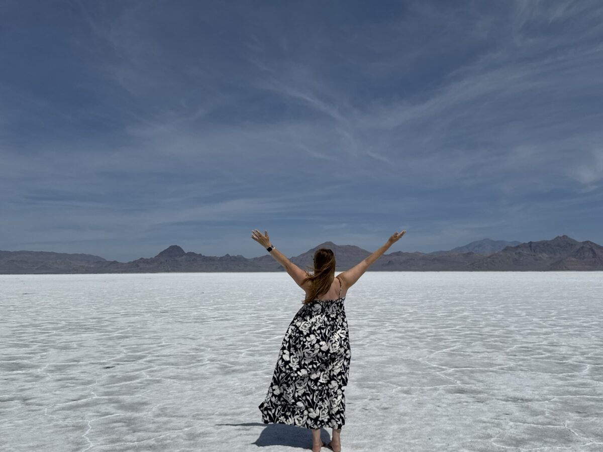 Heidi with her arms raised on the Bonneville Salt Flats